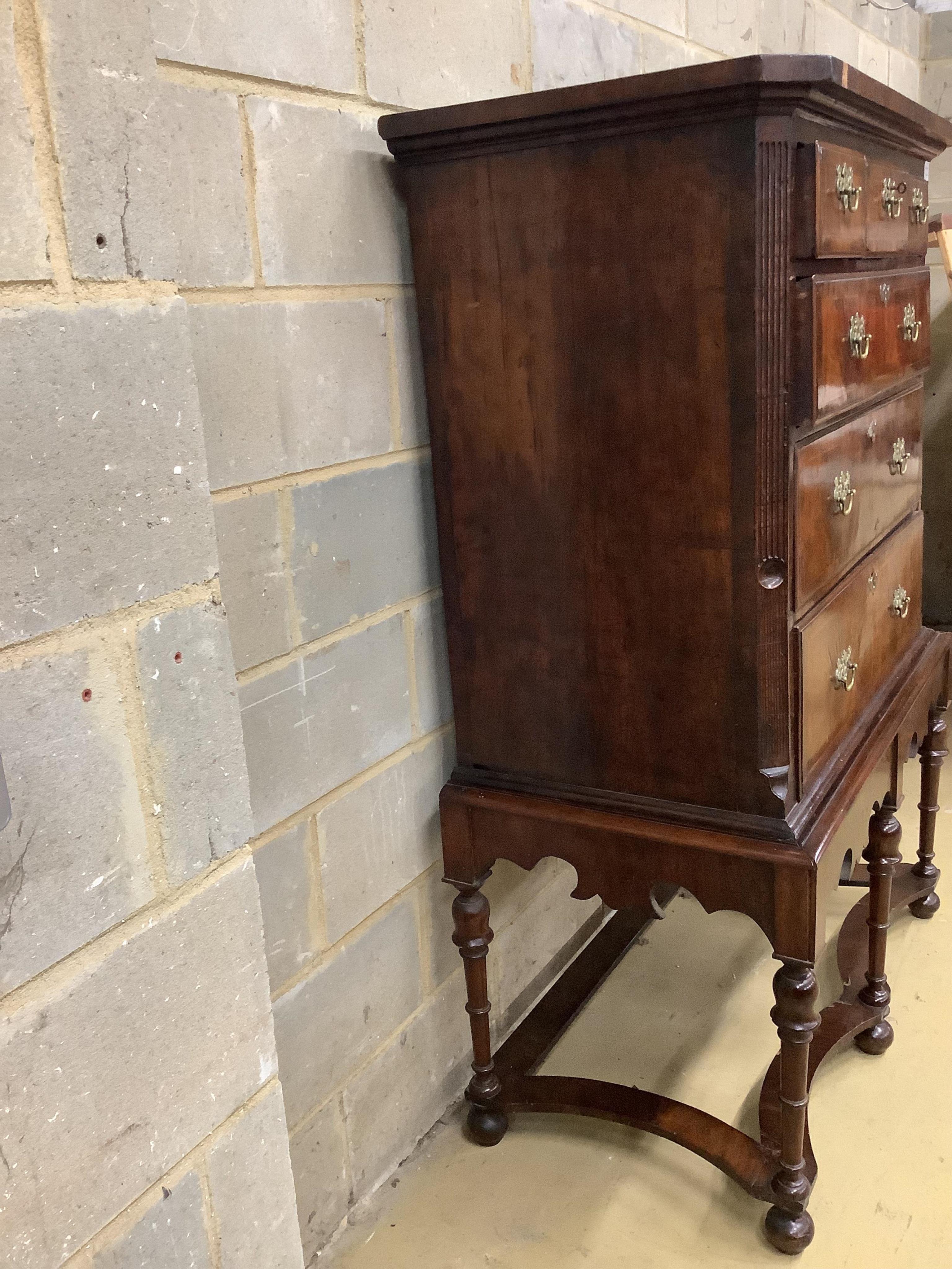 An 18th century walnut chest on later stand, width 106cm, depth 56cm, height 159cm. Condition - fair to good